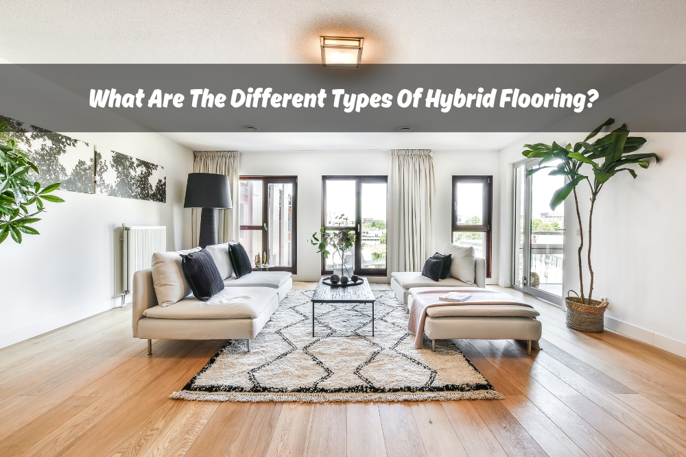 Modern living room with hybrid flooring, featuring a light wood floor, comfortable sofas, a stylish rug, and indoor plants, with text overlay asking 'What Are The Different Types Of Hybrid Flooring?